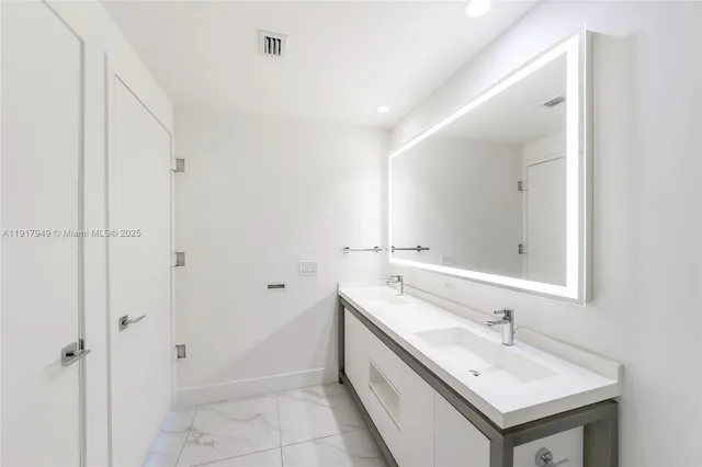 a bathroom with a bathtub sink vanity and mirror