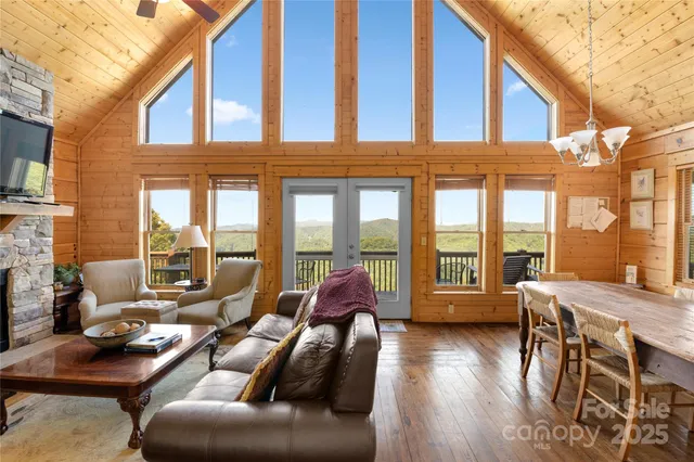 a living room with furniture and floor to ceiling windows
