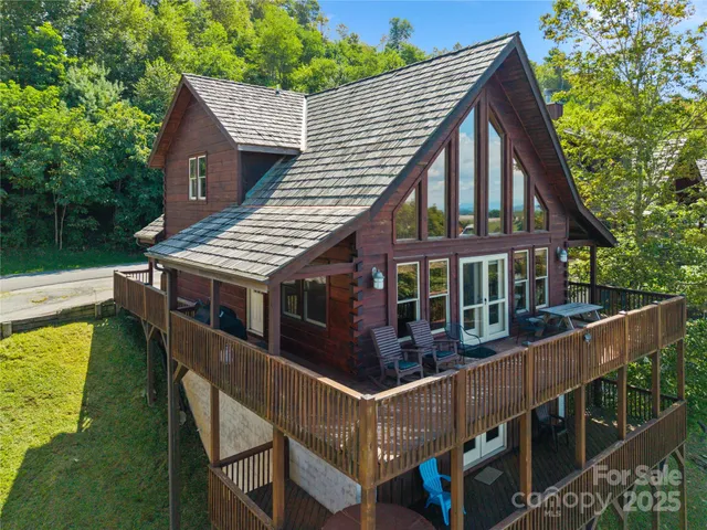 a view of a house with wooden deck and furniture