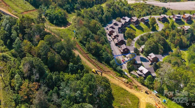 an aerial view of residential houses with outdoor space and street view