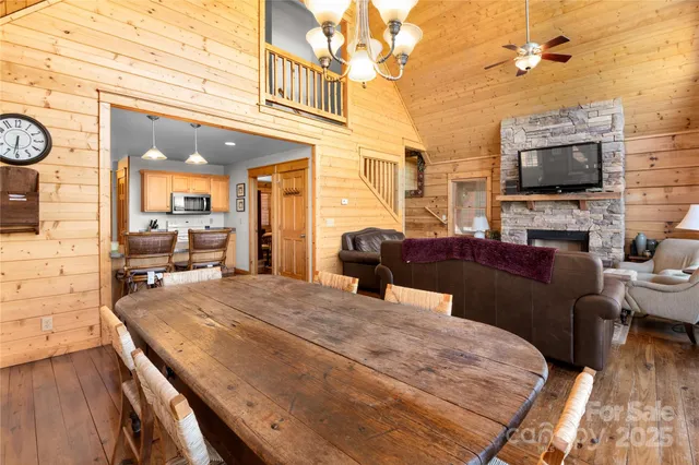 a living room with furniture a flat screen tv and kitchen view