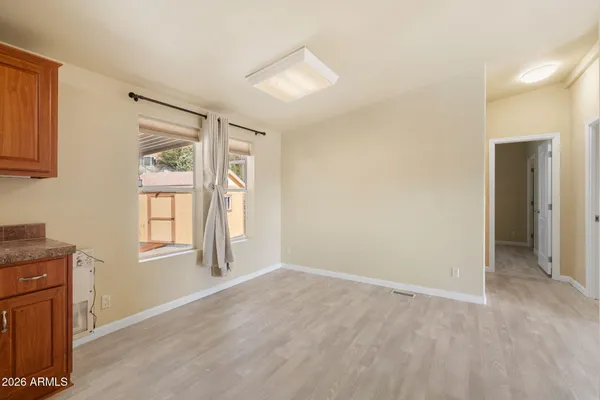 a view of an empty room with window and closet area