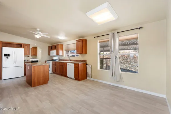 a kitchen with a refrigerator and a wooden cabinets
