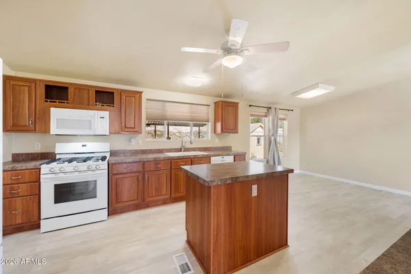 a kitchen with stainless steel appliances granite countertop a sink and stove