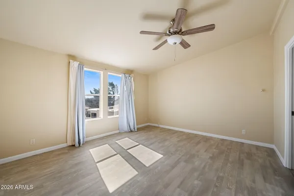 wooden floor in an empty room with a window
