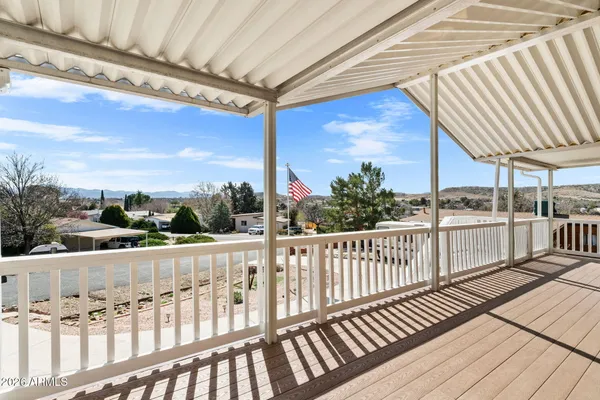 a view of a balcony with wooden floor