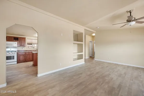 a view of a kitchen with wooden floor and a sink