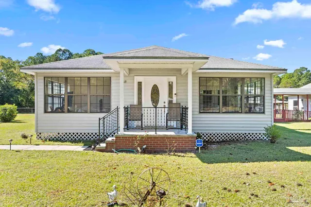 a front view of a house with a swimming pool