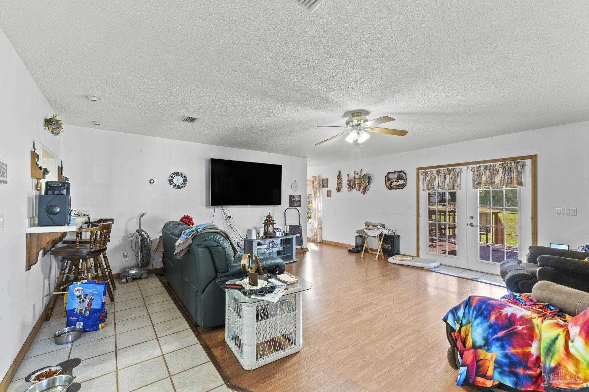 3319 Bob Tolbert Road Navarre, FL 32566 - Photo 15 of 51 a living room with furniture and wooden floor