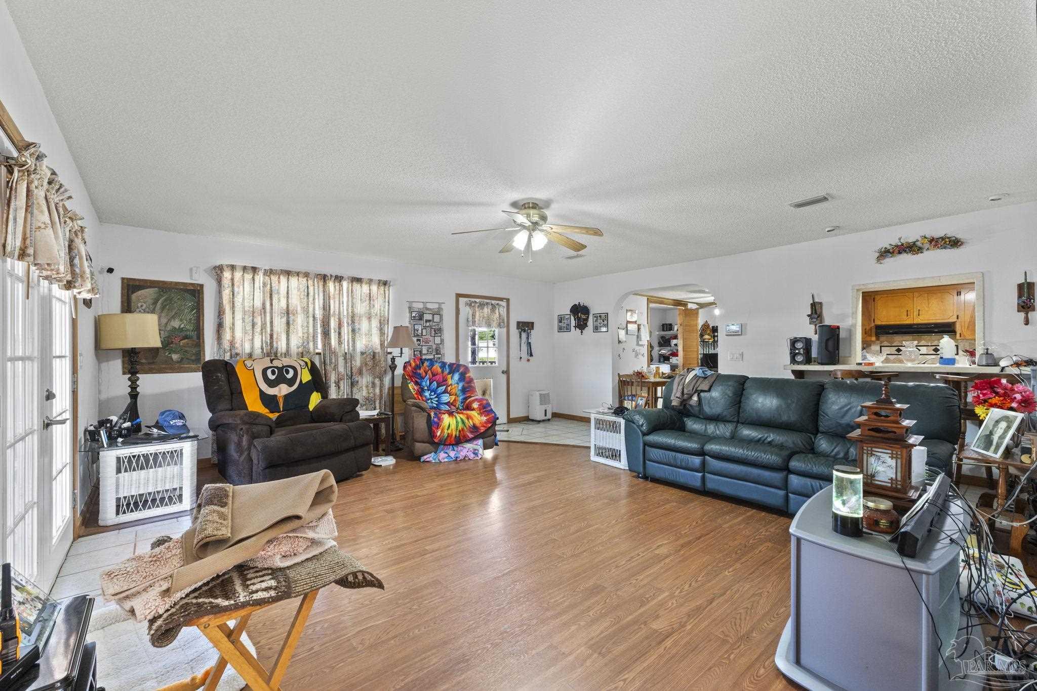 3319 Bob Tolbert Road Navarre, FL 32566 - Photo 16 of 51 a living room with furniture and a flat screen tv