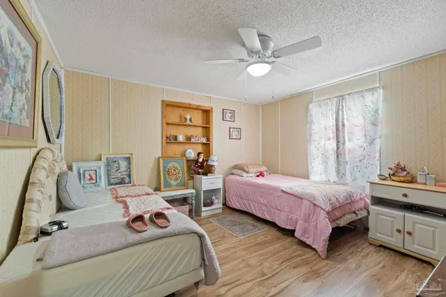 a bedroom with two beds and a chandelier