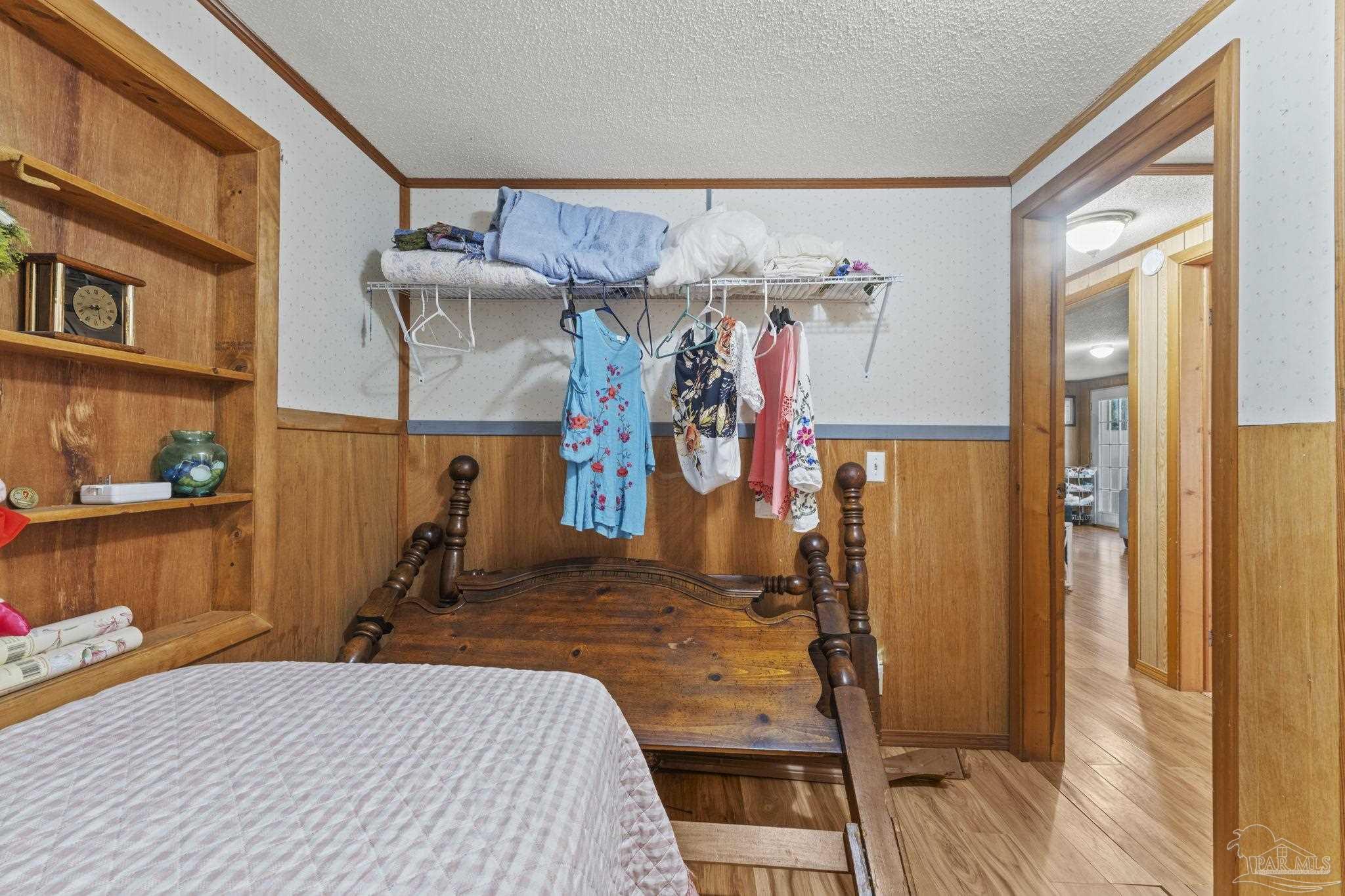 3319 Bob Tolbert Road Navarre, FL 32566 - Photo 26 of 51 a bed room with a bed and a mirror