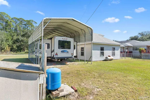 a swimming pool with outdoor seating and yard