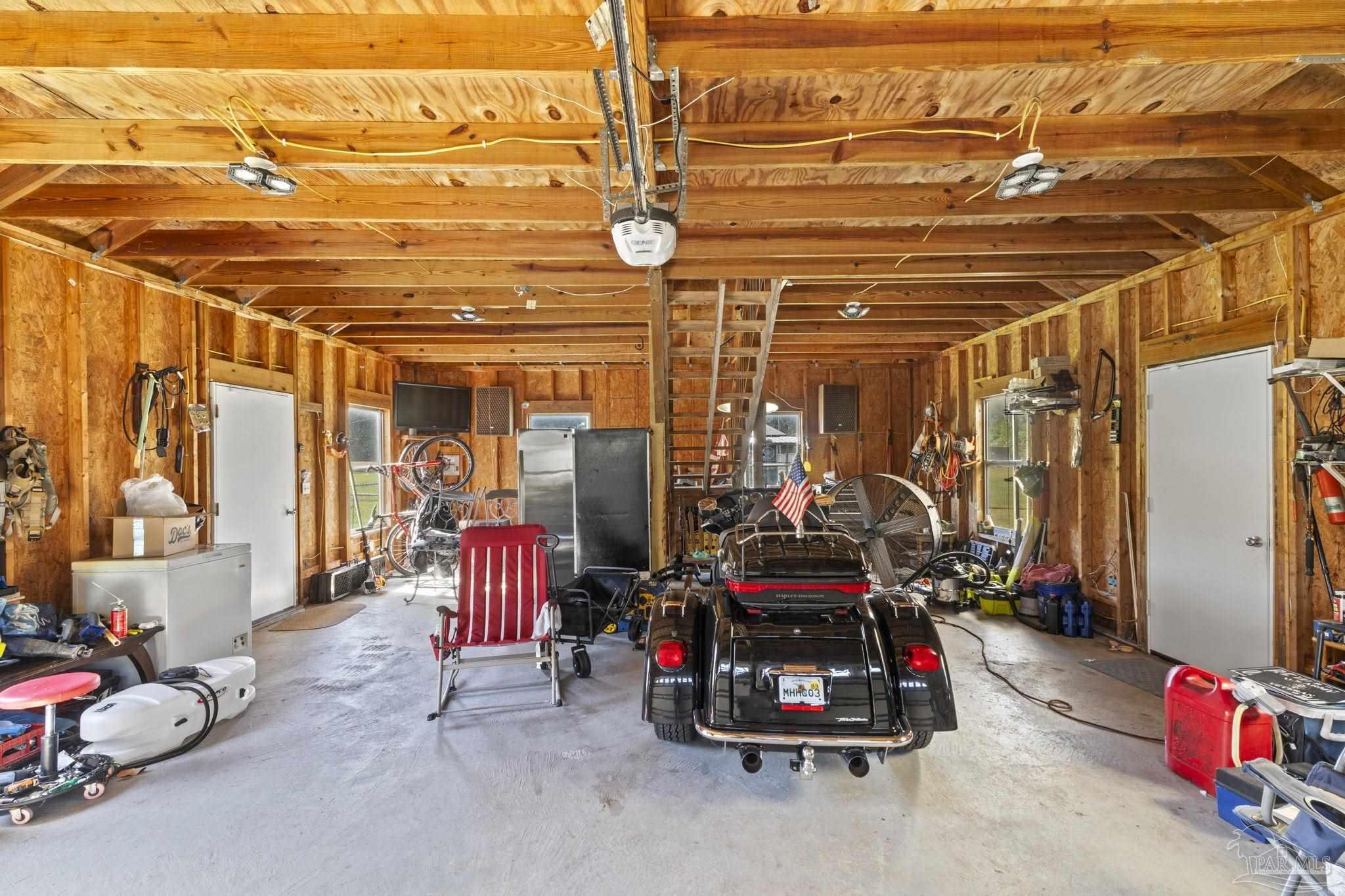 3319 Bob Tolbert Road Navarre, FL 32566 - Photo 31 of 51 a view of a garage with rack and bicycle
