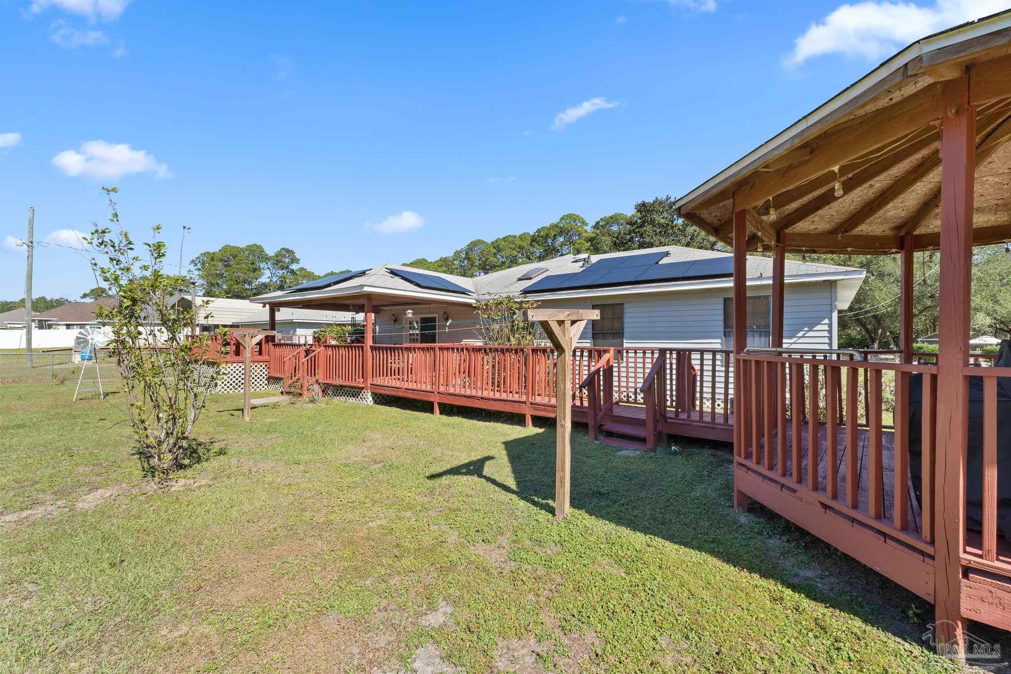 3319 Bob Tolbert Road Navarre, FL 32566 - Photo 34 of 51 an outdoor space with furniture and garden view