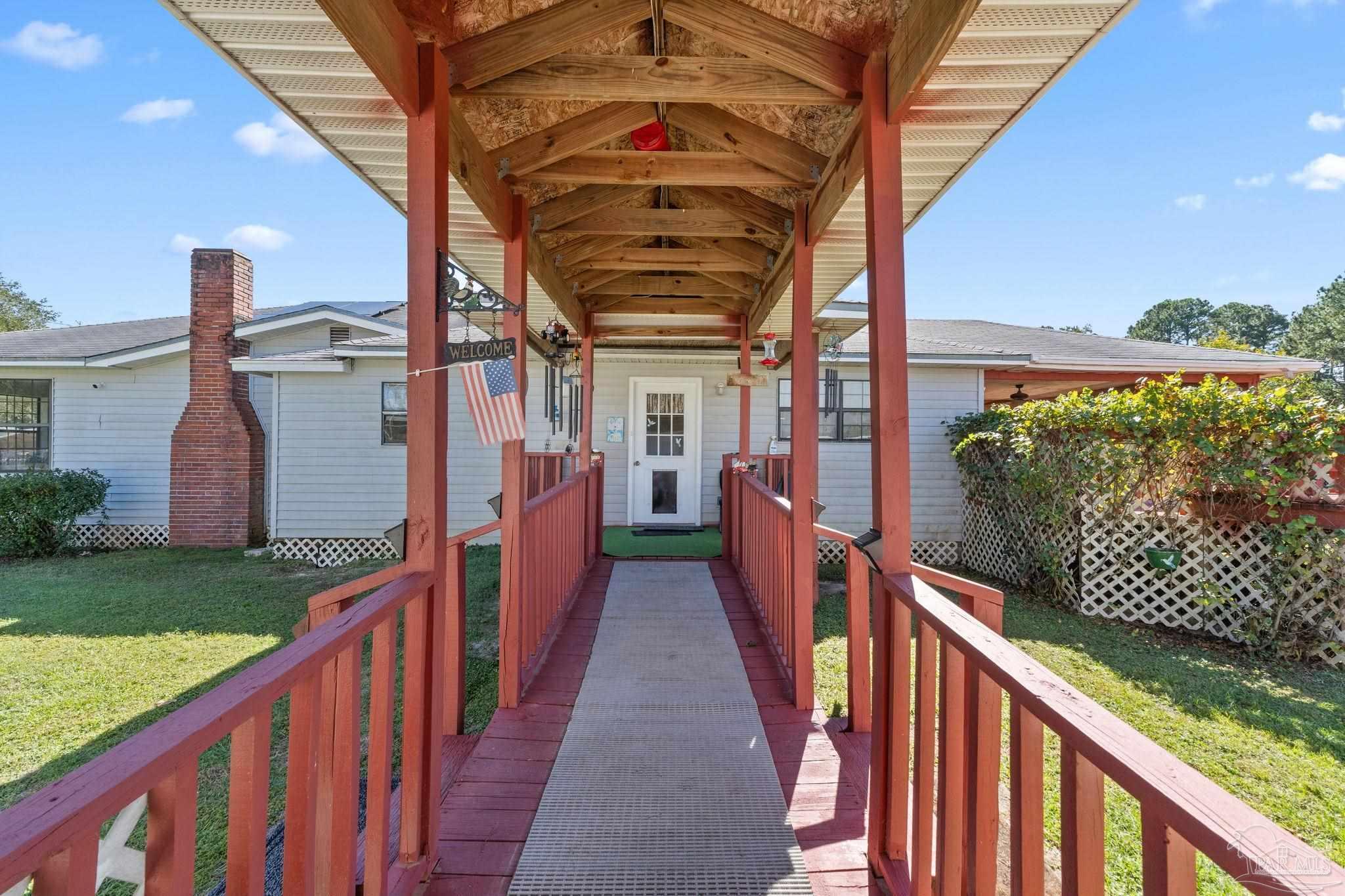 3319 Bob Tolbert Road Navarre, FL 32566 - Photo 37 of 51 a view of a pathway of a building from a balcony