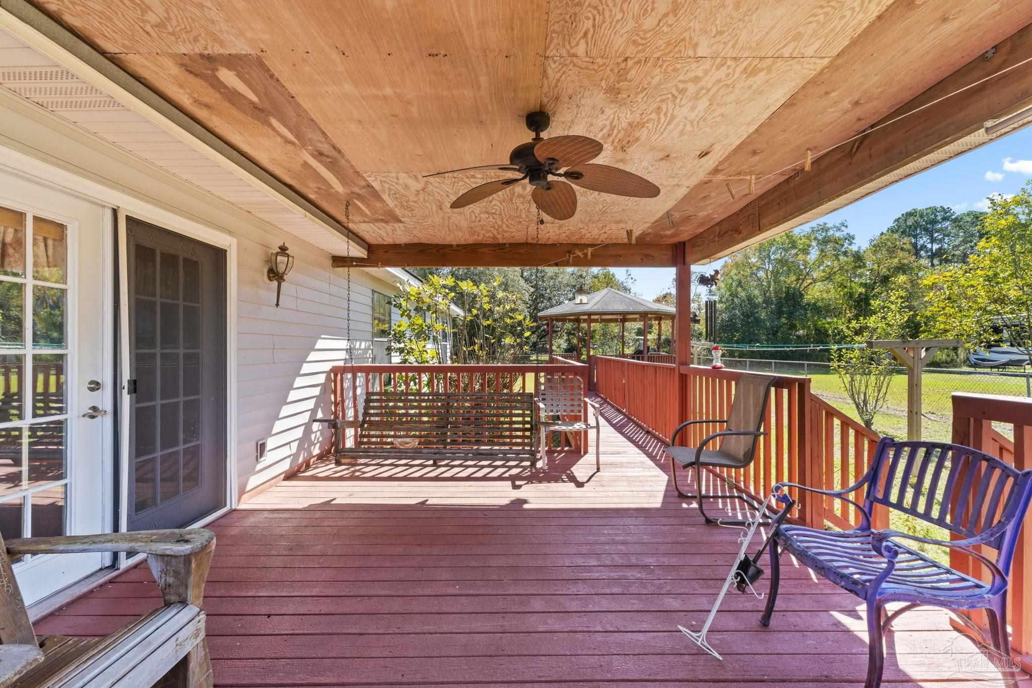 3319 Bob Tolbert Road Navarre, FL 32566 - Photo 38 of 51 a view of a chairs and table in the balcony
