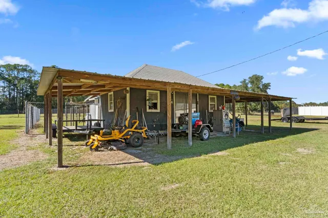 a view of a house with a yard patio and sitting area