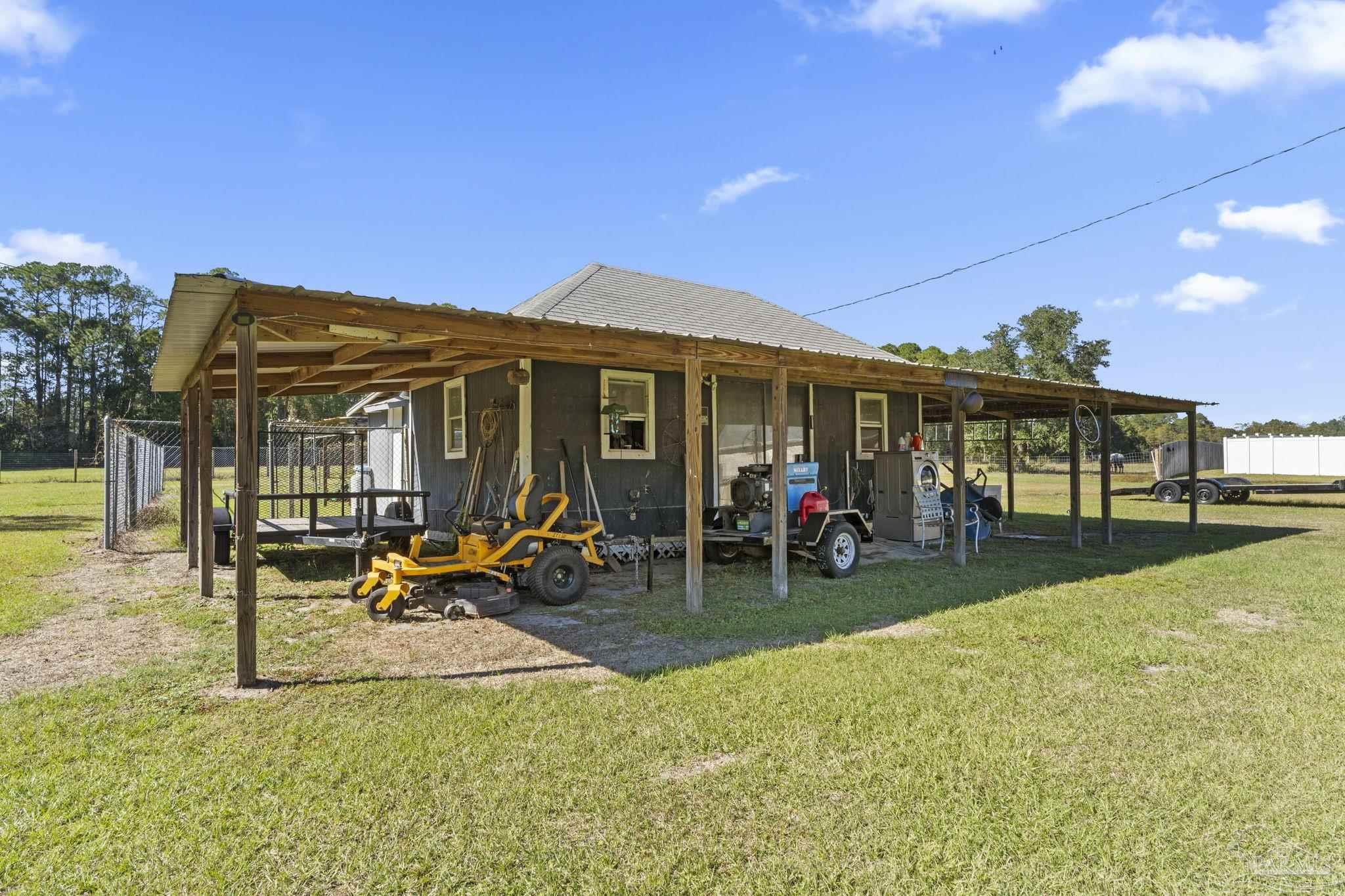 3319 Bob Tolbert Road Navarre, FL 32566 - Photo 39 of 51 a view of a house with swimming pool and sitting area