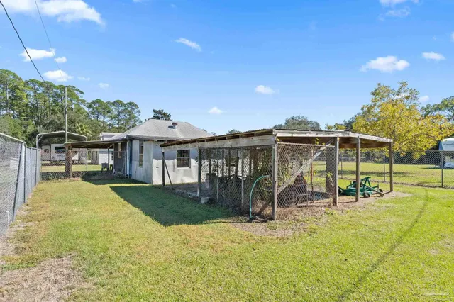 a view of a backyard with swimming pool