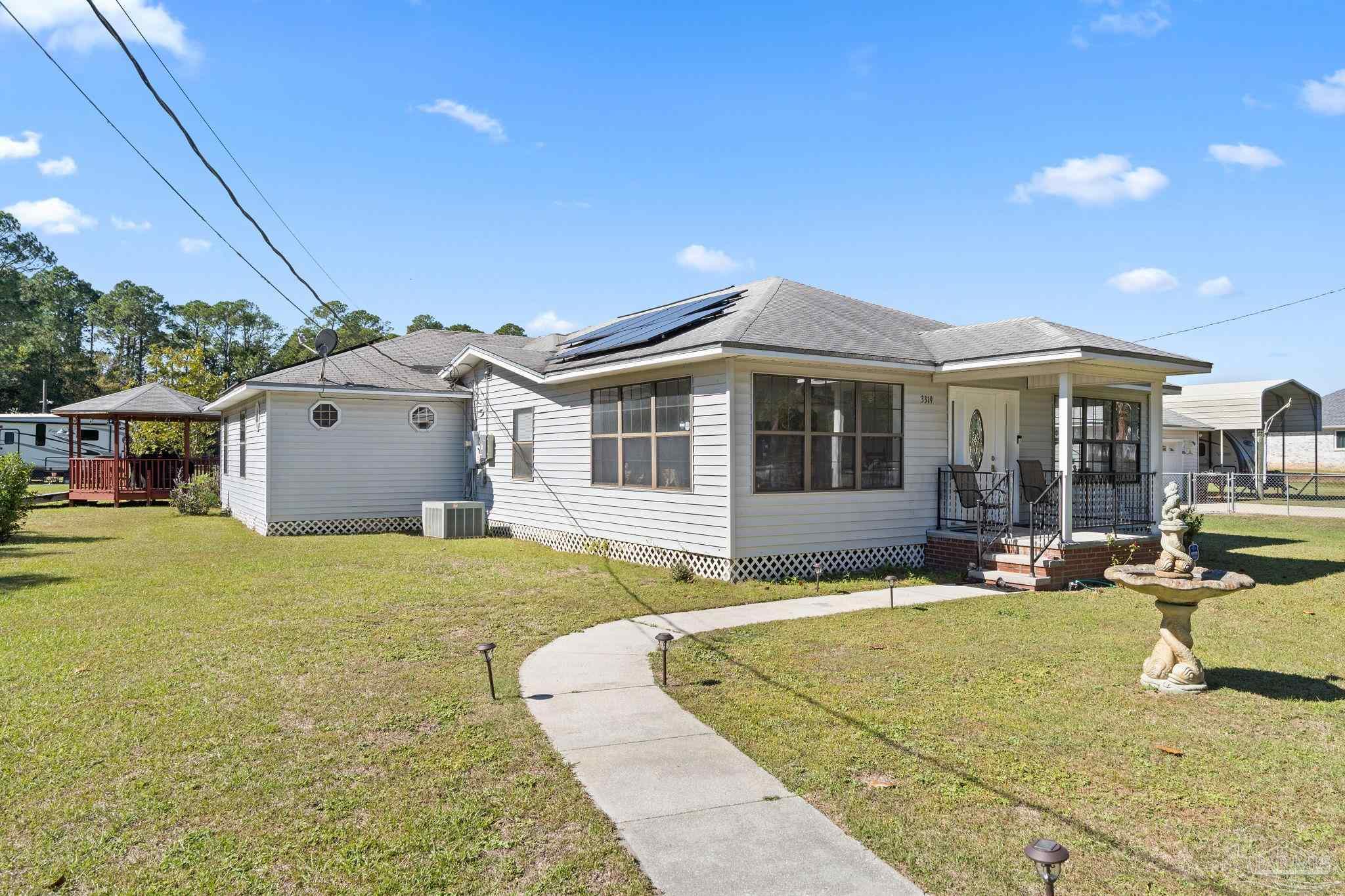 3319 Bob Tolbert Road Navarre, FL 32566 - Photo 4 of 51 a front view of a house with swimming pool