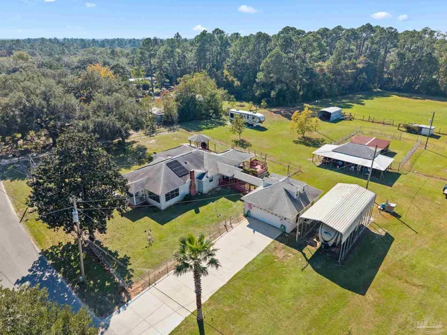 an aerial view of residential houses with outdoor space