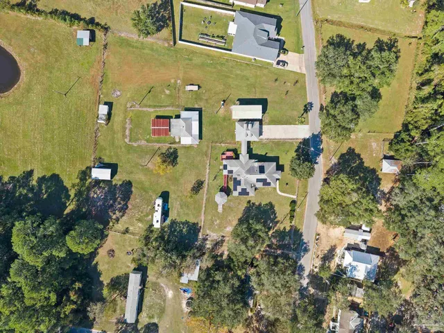 an aerial view of a house with a yard