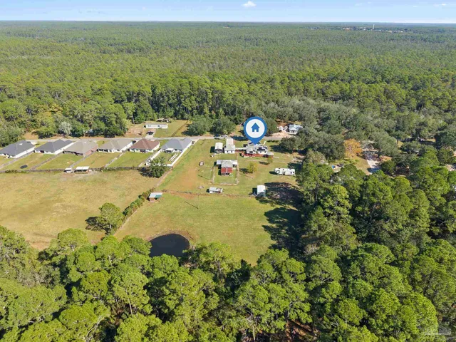 an aerial view of a house with a swimming pool