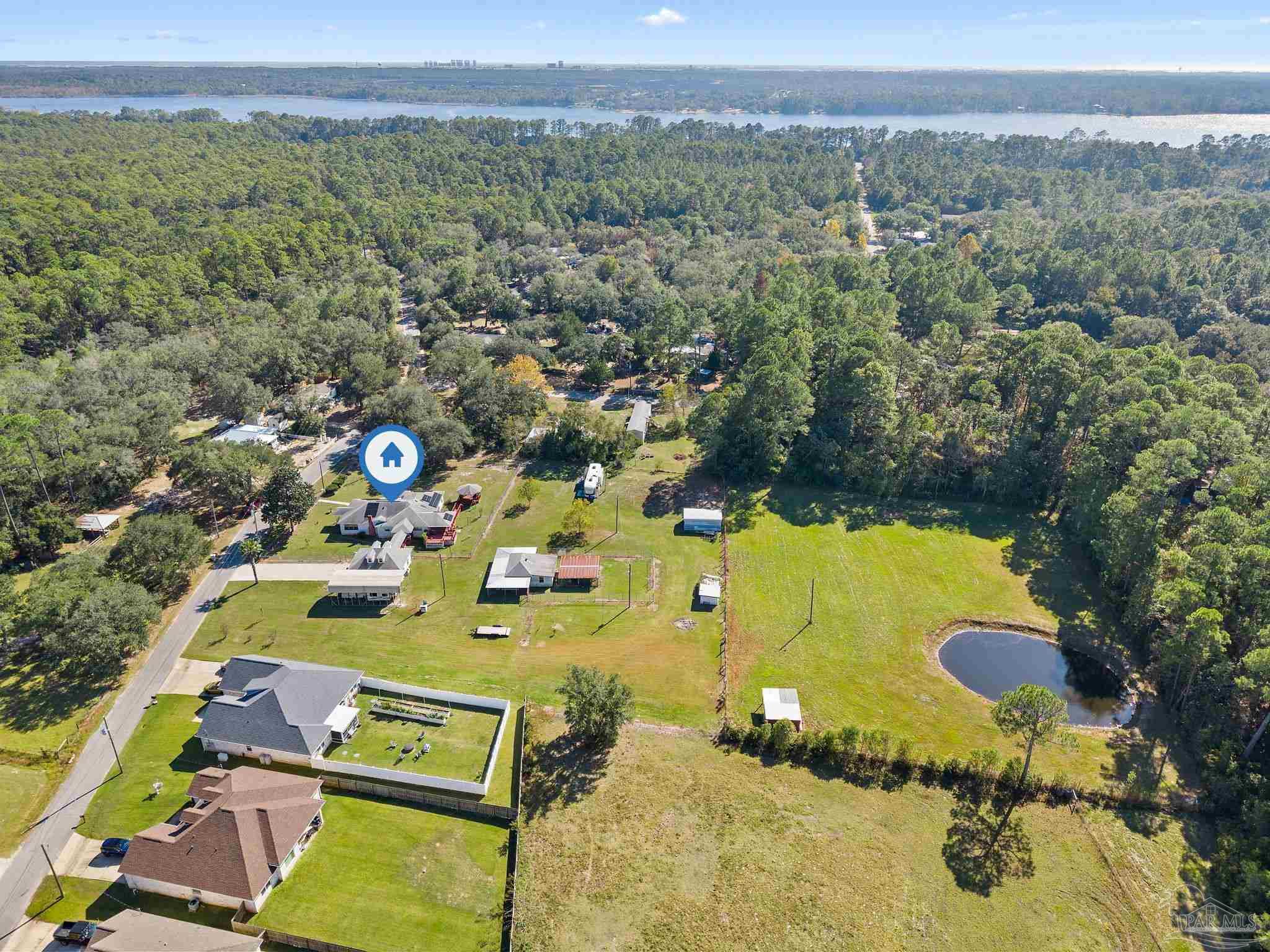 3319 Bob Tolbert Road Navarre, FL 32566 - Photo 50 of 51 an aerial view of a house with a swimming pool