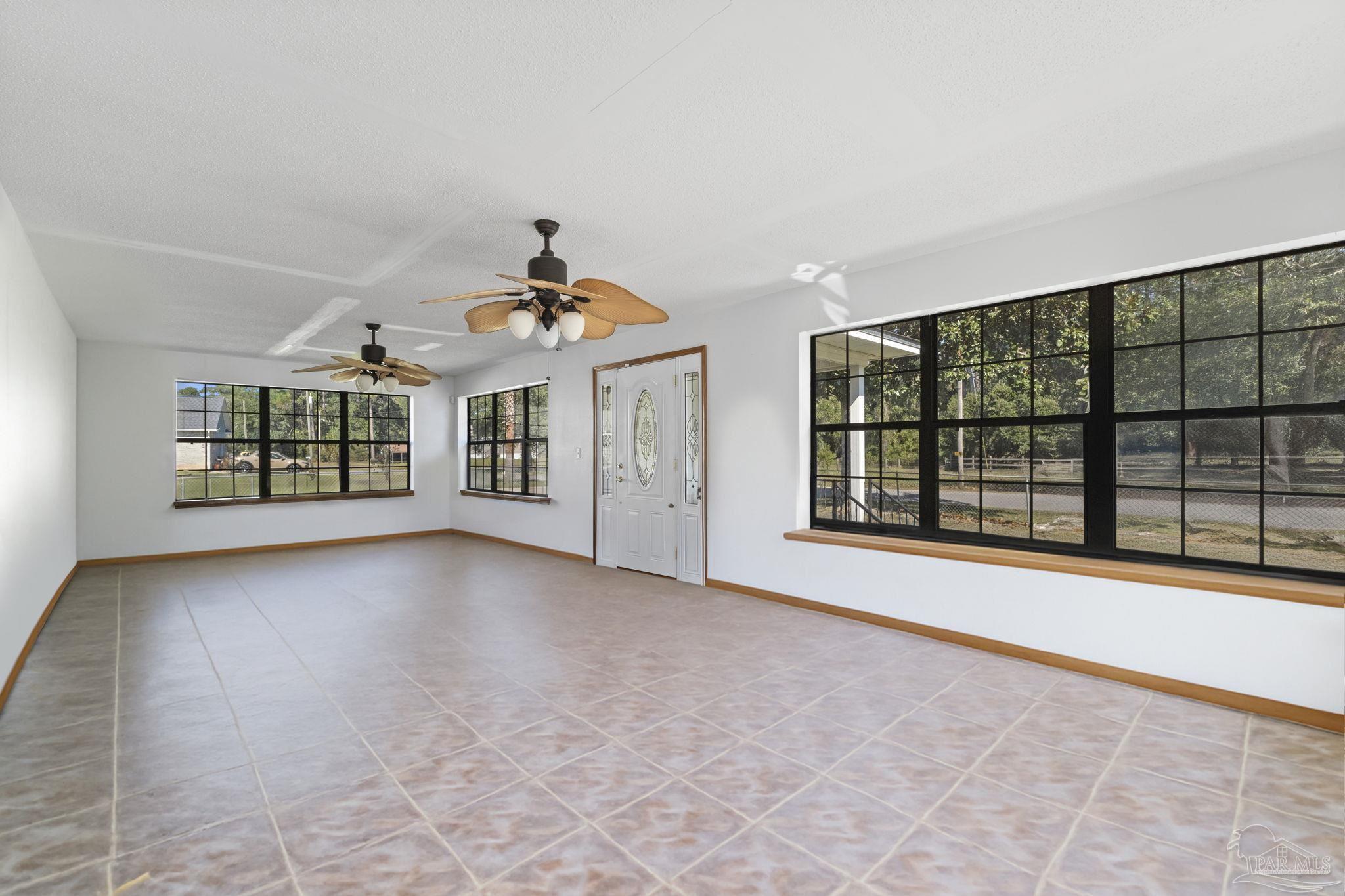 3319 Bob Tolbert Road Navarre, FL 32566 - Photo 7 of 51 a view of a big room with windows