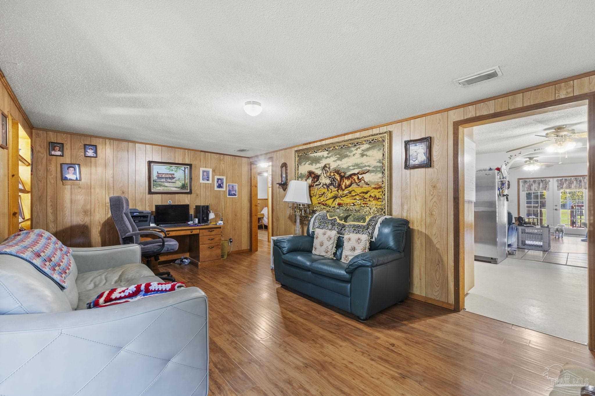 3319 Bob Tolbert Road Navarre, FL 32566 - Photo 8 of 51 a living room with furniture and a flat screen tv