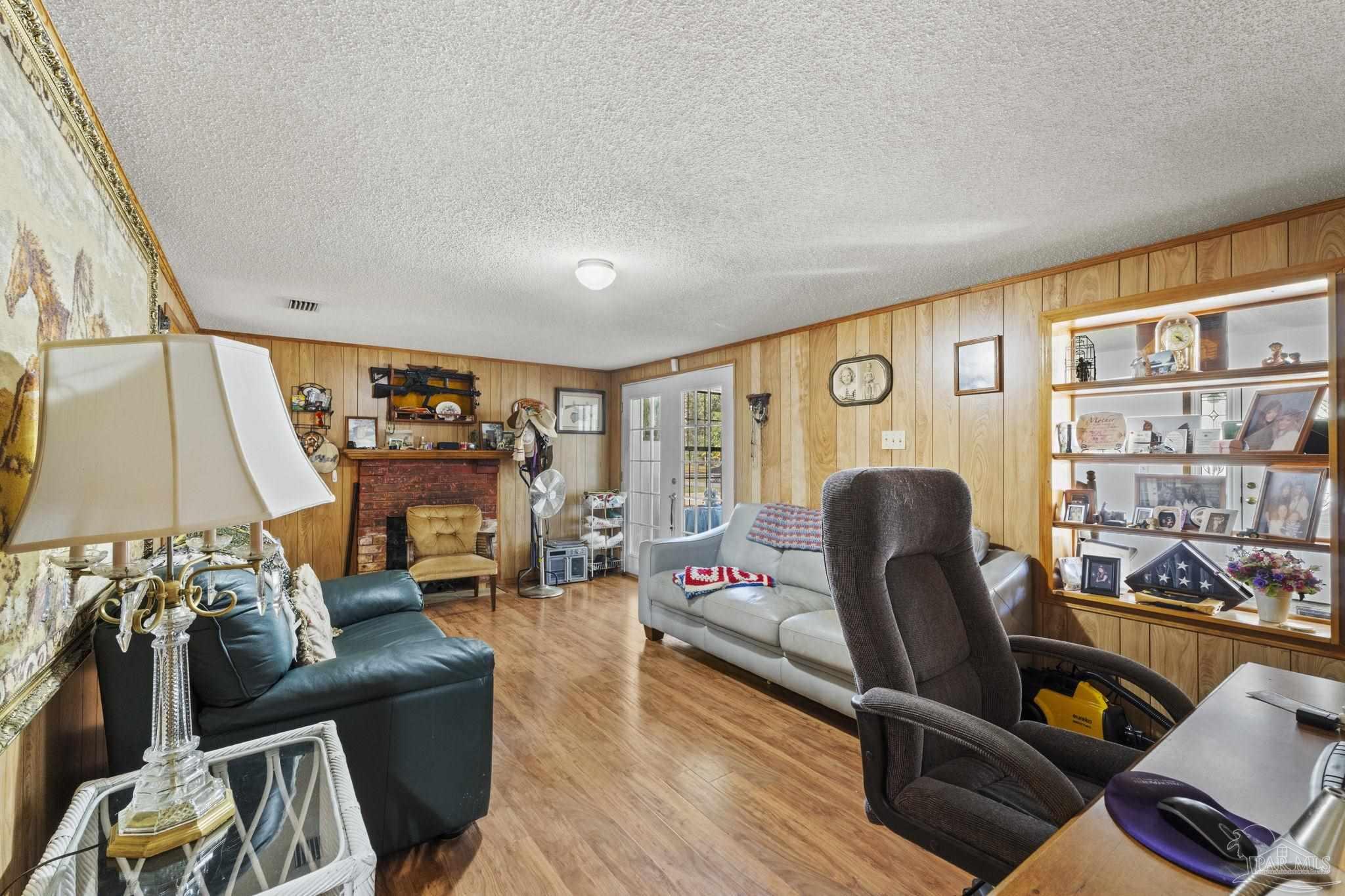 3319 Bob Tolbert Road Navarre, FL 32566 - Photo 9 of 51 a living room with furniture and a flat screen tv