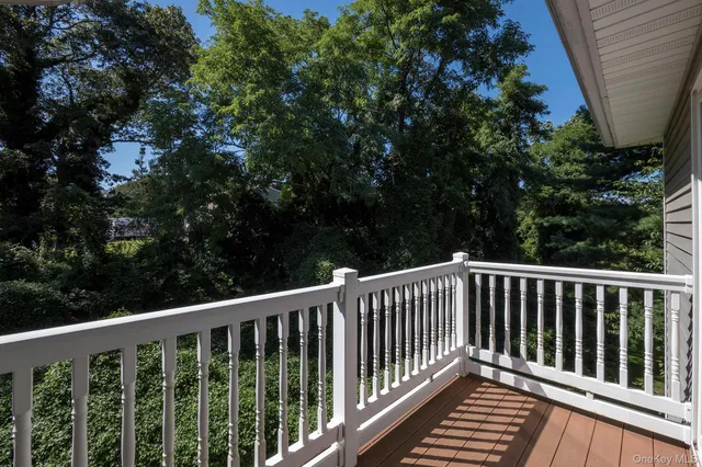 a balcony with wooden floor in outdoor space