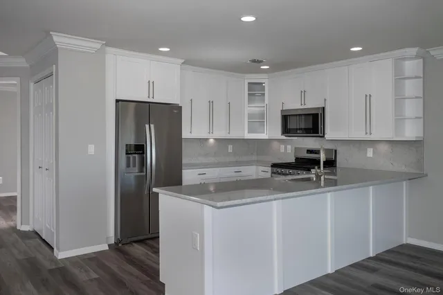 a kitchen with stainless steel appliances granite countertop a refrigerator sink and microwave