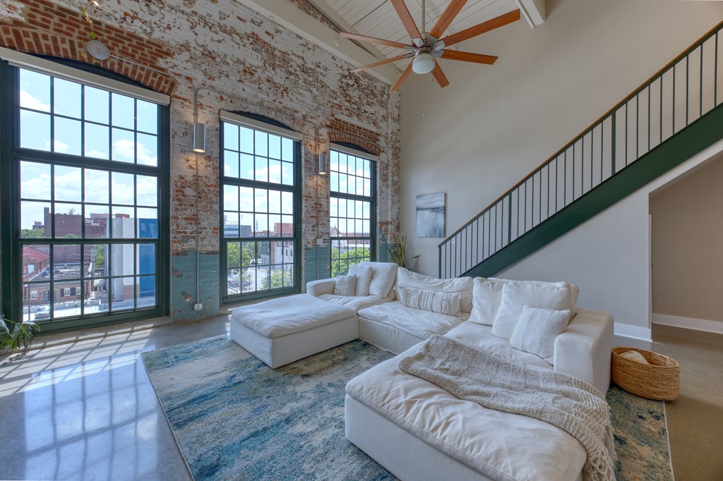 1201 Front Avenue, Unit 522 Columbus, GA 31901 - Photo 15 of 56 a living room with furniture and a floor to ceiling window