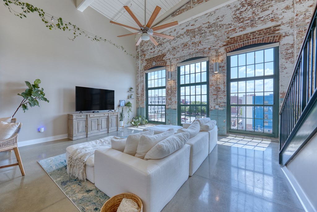 1201 Front Avenue, Unit 522 Columbus, GA 31901 - Photo 16 of 56 a living room with furniture and a flat screen tv