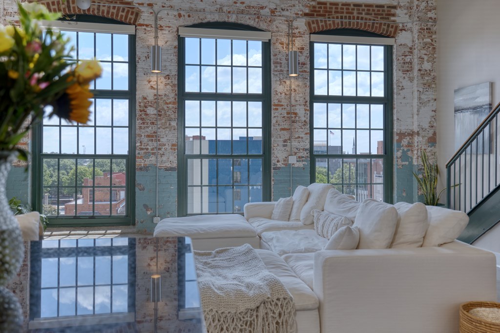 1201 Front Avenue, Unit 522 Columbus, GA 31901 - Photo 17 of 56 a living room with furniture and a floor to ceiling window
