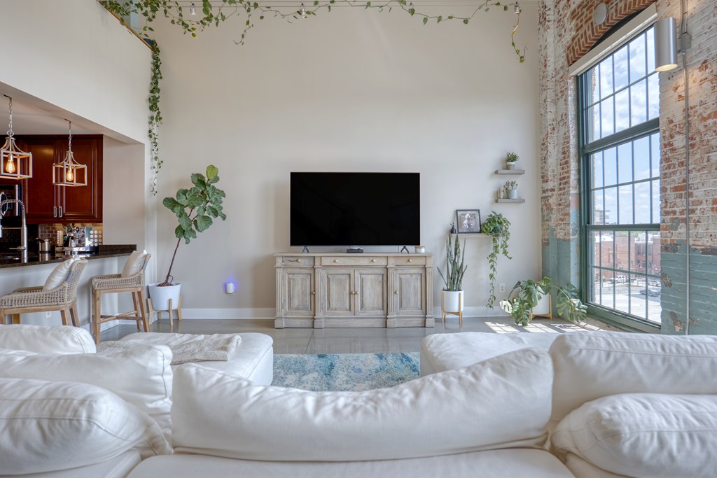 1201 Front Avenue, Unit 522 Columbus, GA 31901 - Photo 18 of 56 a living room with furniture and a flat screen tv