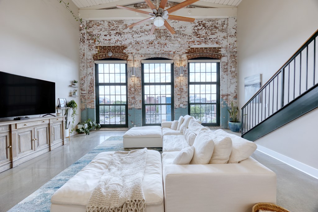 1201 Front Avenue, Unit 522 Columbus, GA 31901 - Photo 19 of 56 a living room with furniture and a flat screen tv