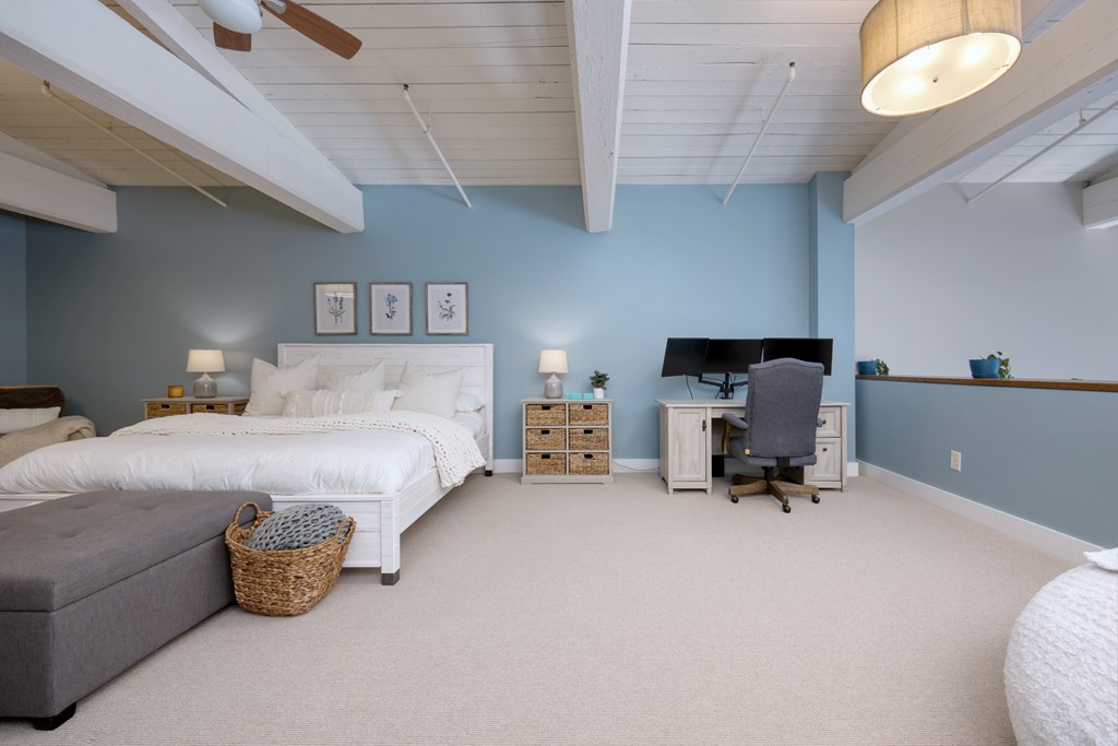 1201 Front Avenue, Unit 522 Columbus, GA 31901 - Photo 27 of 56 a bedroom with a bed and a chair