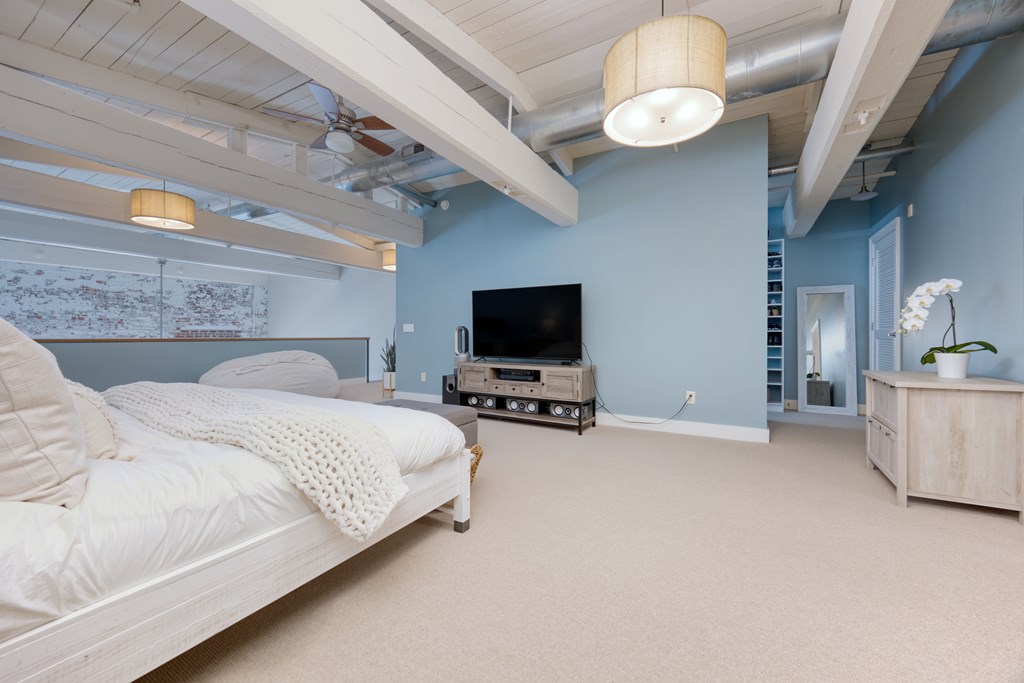 1201 Front Avenue, Unit 522 Columbus, GA 31901 - Photo 34 of 56 a bedroom with bed and a flat screen tv