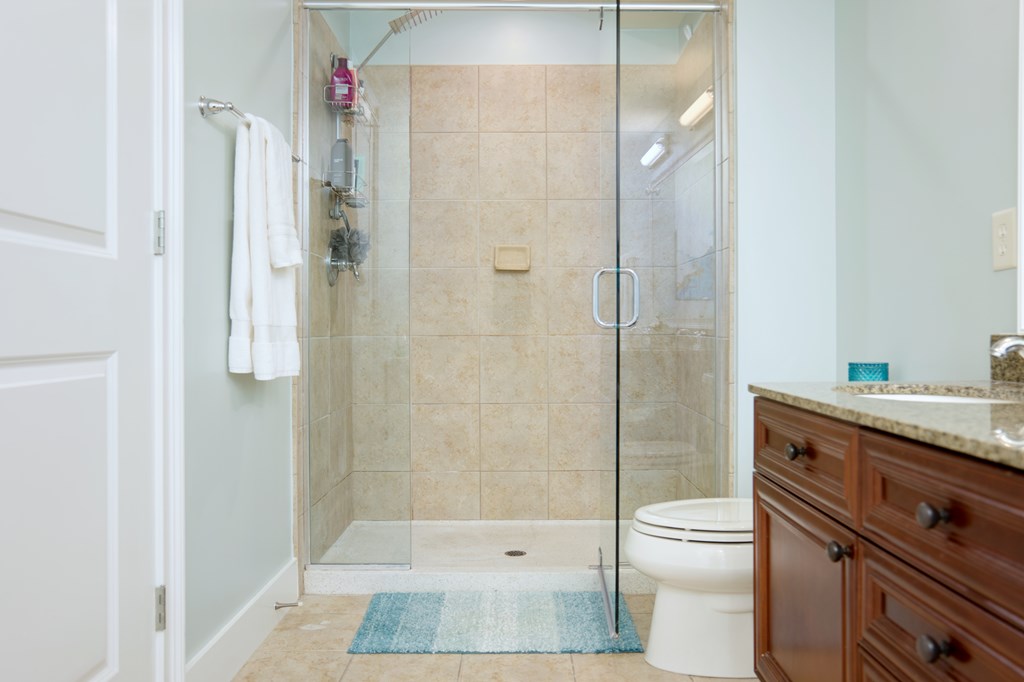 1201 Front Avenue, Unit 522 Columbus, GA 31901 - Photo 37 of 56 a bathroom with a granite countertop shower a toilet and a sink