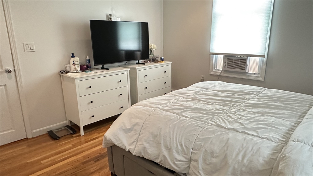 46-48 Buckley Street Quincy, MA 02169 - Photo 16 of 42 a bedroom with a bed and a flat screen tv