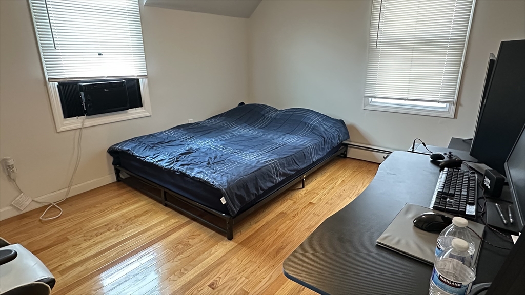 46-48 Buckley Street Quincy, MA 02169 - Photo 17 of 42 a living room with a bed furniture and a flat screen tv