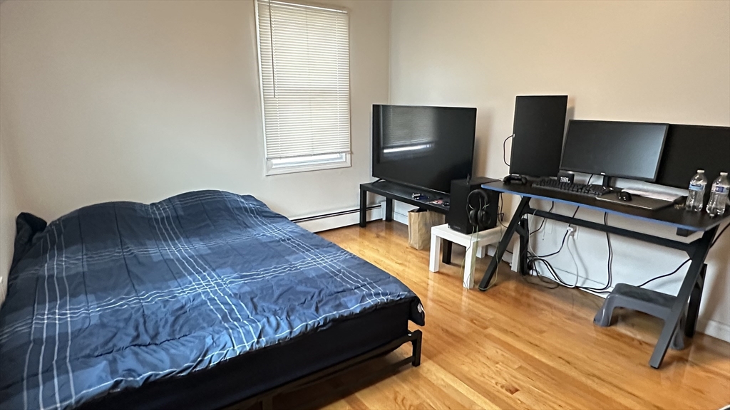 46-48 Buckley Street Quincy, MA 02169 - Photo 18 of 42 a bedroom with a bed and a desk