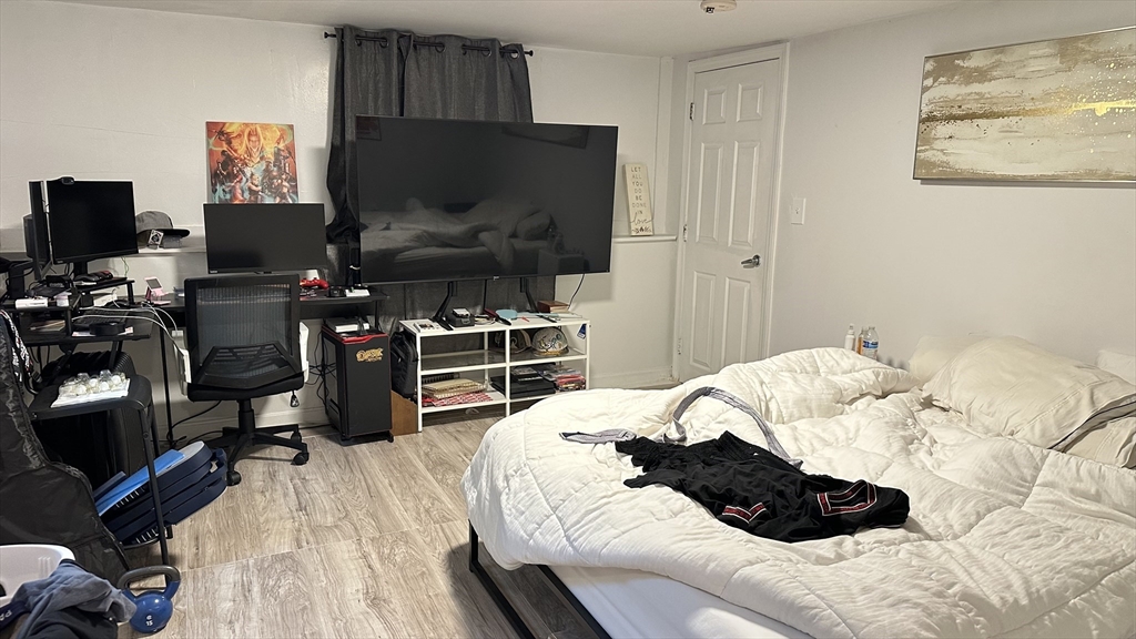46-48 Buckley Street Quincy, MA 02169 - Photo 21 of 42 a bedroom with a bed and a flat screen tv