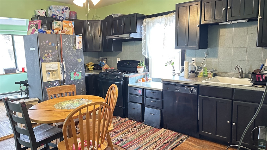 46-48 Buckley Street Quincy, MA 02169 - Photo 30 of 42 a kitchen with stainless steel appliances wooden floors and wooden cabinets