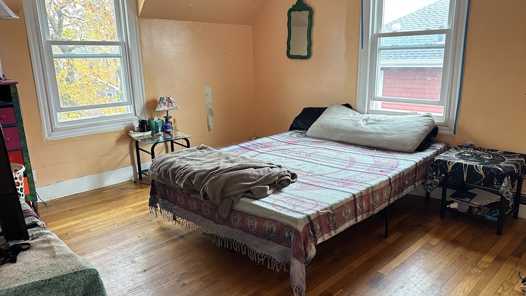 46-48 Buckley Street Quincy, MA 02169 - Photo 33 of 42 a bedroom with a bed and wooden floor
