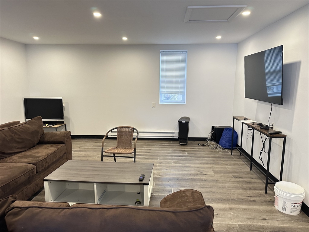46-48 Buckley Street Quincy, MA 02169 - Photo 4 of 42 a living room with furniture and a flat screen tv