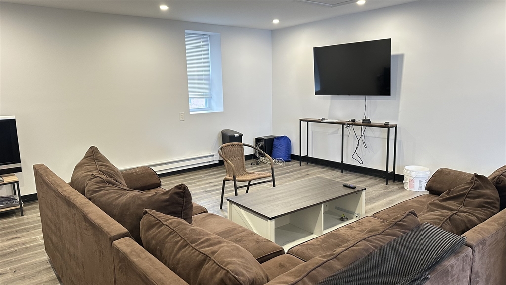 46-48 Buckley Street Quincy, MA 02169 - Photo 5 of 42 a living room with furniture and a flat screen tv